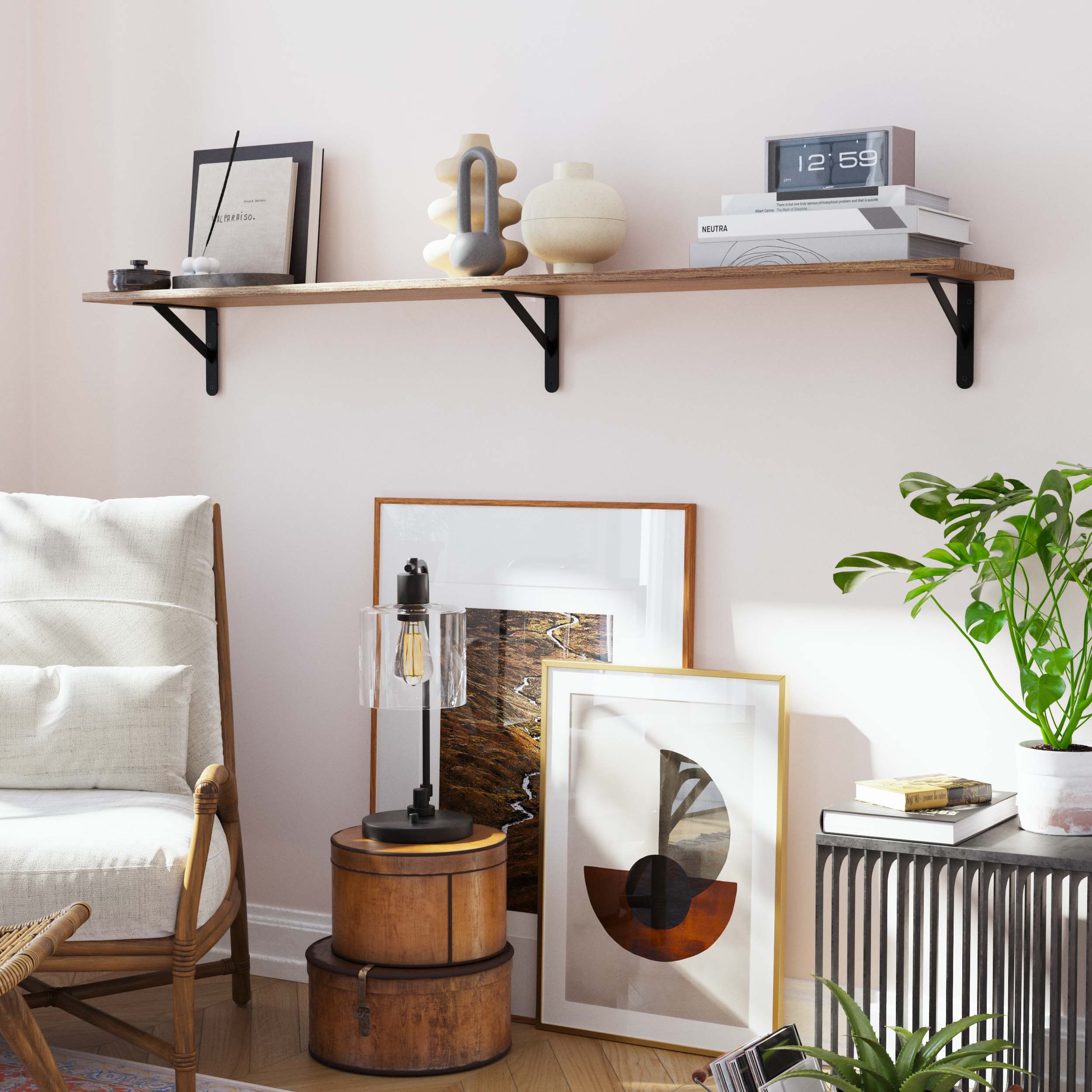 Floating wall shelf styled with modern decor, including abstract art and ceramics. The warm wooden tones and black metal brackets complement a cozy and eclectic room setup.