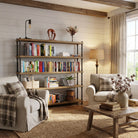 Cozy living room with rustic 5 tiered bookshelf, armchairs, and coffee table.