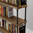 Real wood bookshelf with books, including 'Lead the Way' and 'Balanced Ministry', on a plain background.