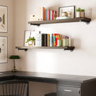 Home office setup with a desk, farmhouse pipe shelves, books, and decorative items.
