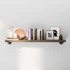 48" black industrial pipe shelf with decorative items including books, a plate, and small sculptures against a white wall.