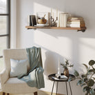 Cozy living room with a chair, boho shelf, and decorative items.
