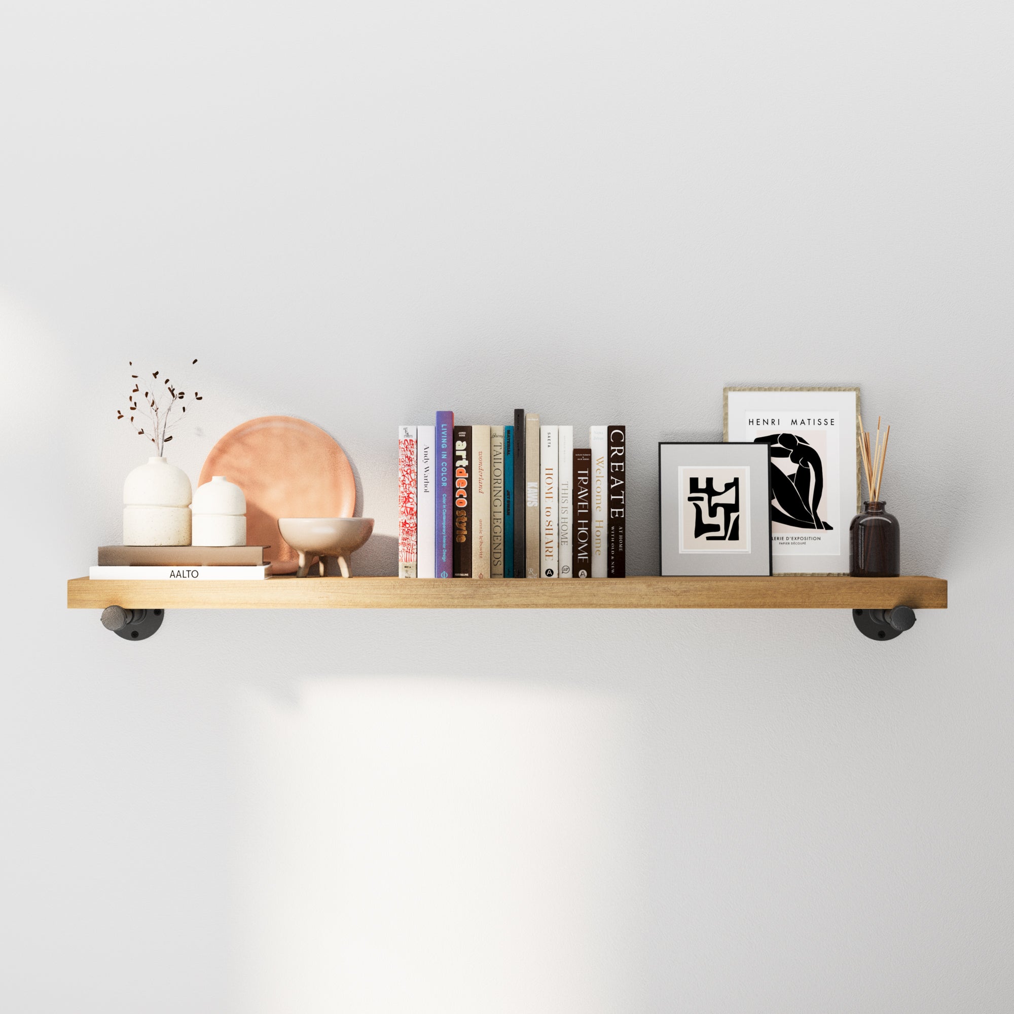 Boho shelf with decorative items on a white wall