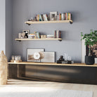 Long wall shelves styled in a modern living room, creating functional storage for books, plants, and décor. These industrial floating shelves add farmhouse charm, wall organization, and space-saving display storage.