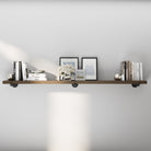 72 inch industrial pipe shelf in a rich dark walnut finish, styled with books and wall décor for a refined rustic-modern look. This extra long floating bookshelf adds elegant storage to living rooms, offices, bedrooms, or kitchens.