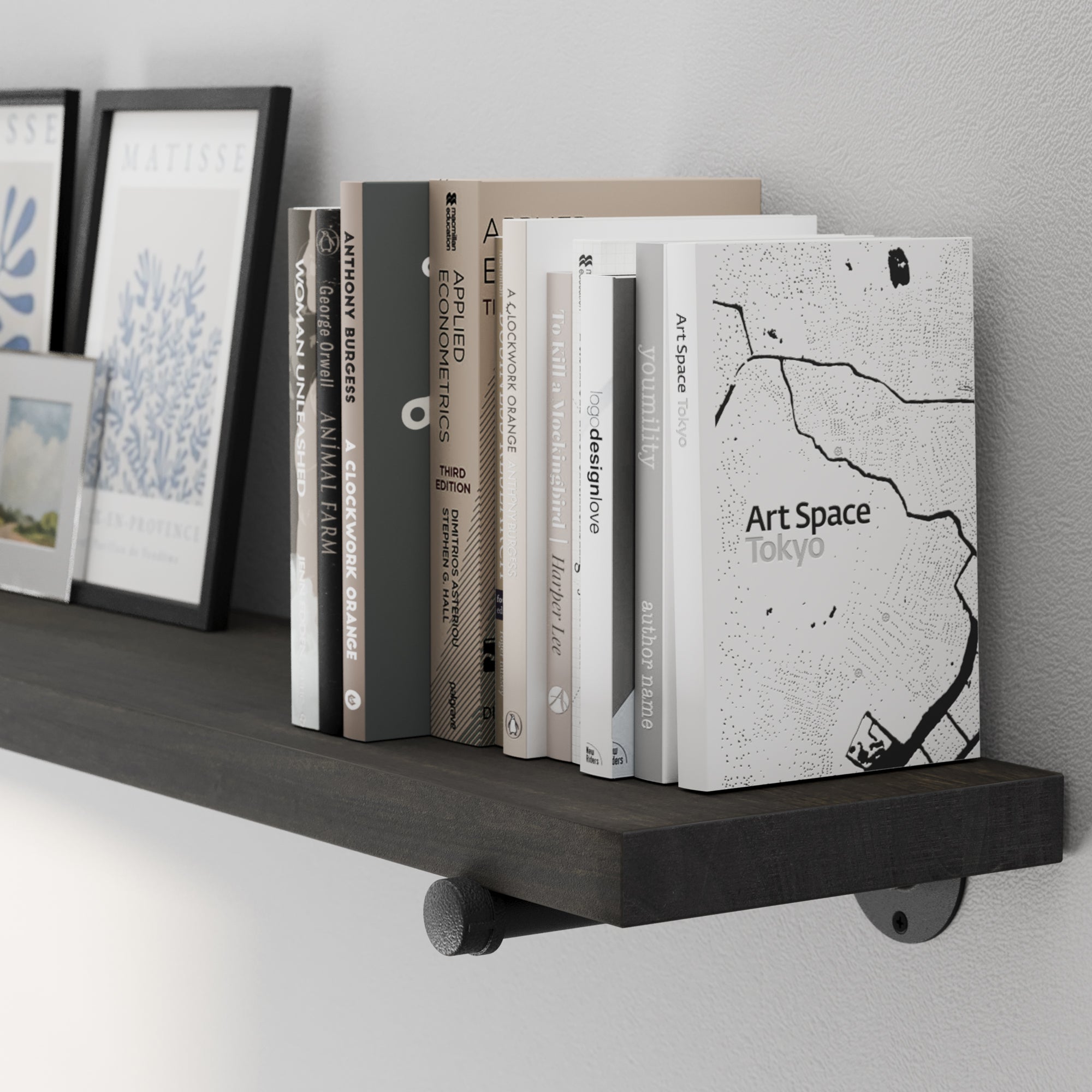 A 72” floating pipe shelf showcasing a rich ebony wood finish and sturdy black metal pipe brackets. A long floating bookshelf ideal for displaying books, framed prints, collectibles, and minimalist home décor.