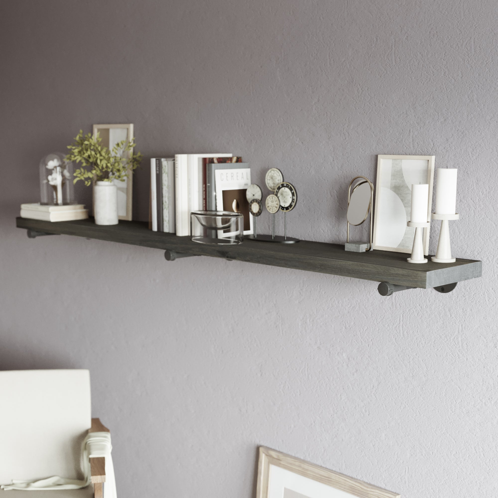72 inch long wall mounted pipe shelf mounted on a textured wall, creating functional wall storage with elegant contrast. This 72 inch long shelf is ideal for organizing books, candles, plants, and decorative accents in modern interiors.