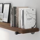 A 72” long floating pipe shelf featuring a rich provincial wood finish and sturdy black pipe brackets. A long bookshelf wall shelf designed for books, framed prints, collectibles, and modern rustic home décor.