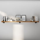72 inch industrial pipe shelf with a rich Special Walnut finish, styled with books, framed art, and décor accents. This extra long wall shelf blends rustic warmth and modern industrial style for living room, office, or bedroom storage.