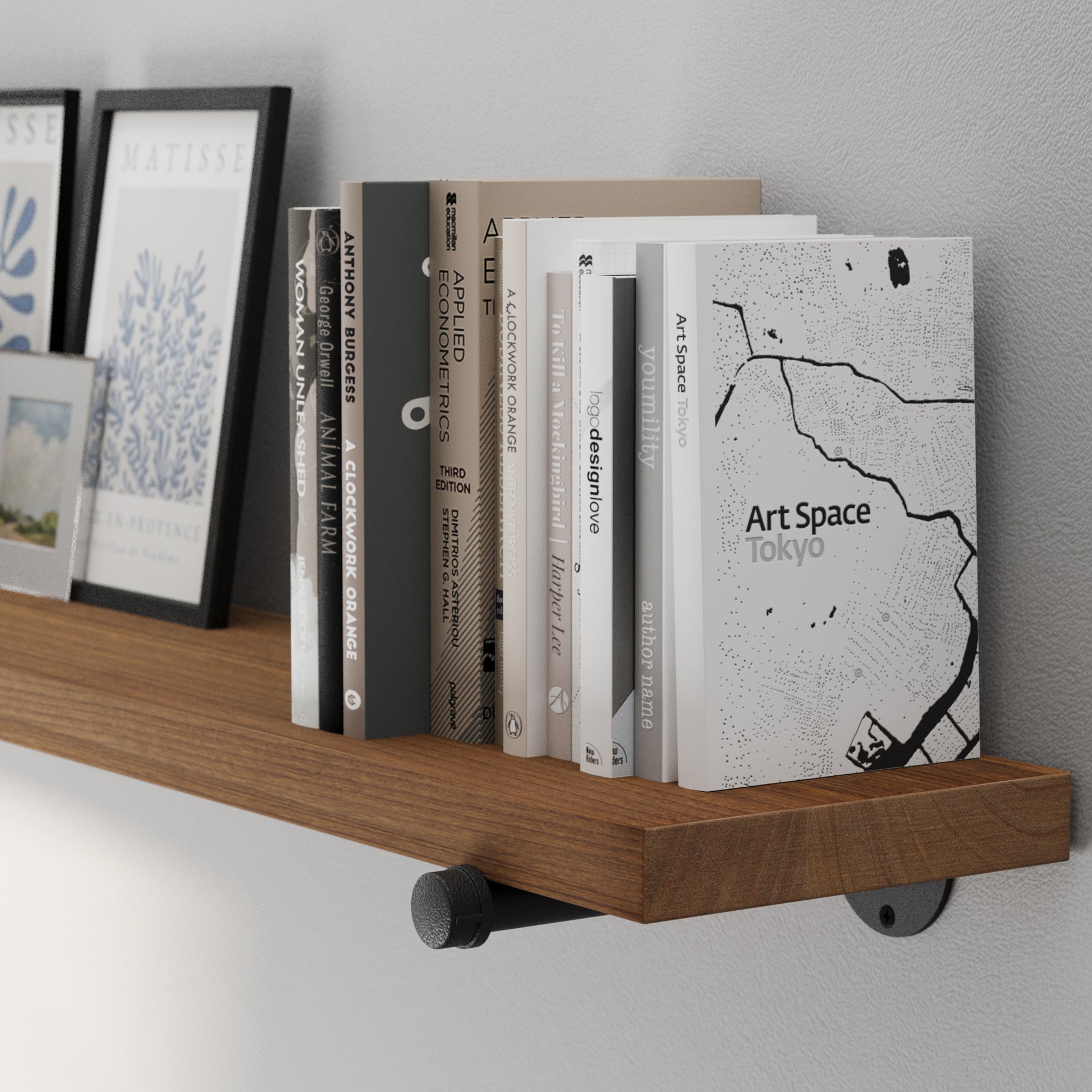 A 72” long 1.5" thick floating book shelf featuring a smooth Special Walnut wood finish and black pipe brackets. A long floating bookshelf for displaying books, framed photos, collectibles, and farmhouse-inspired home décor.
