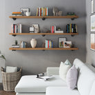 Three pieces of 72 inch long wall bookshelves with black pipe brackets in a Special Walnut finish. These extra long shelves maximize wall storage for books, plants, decorative pieces, and rustic-modern organization in living spaces.