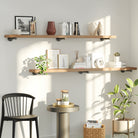 Golden oak wooden pipe shelves styled in a bright living space, offering open wall storage and decorative display. These 72 inch long shelves create a warm farmhouse aesthetic for books, plants, candles, and home accents.