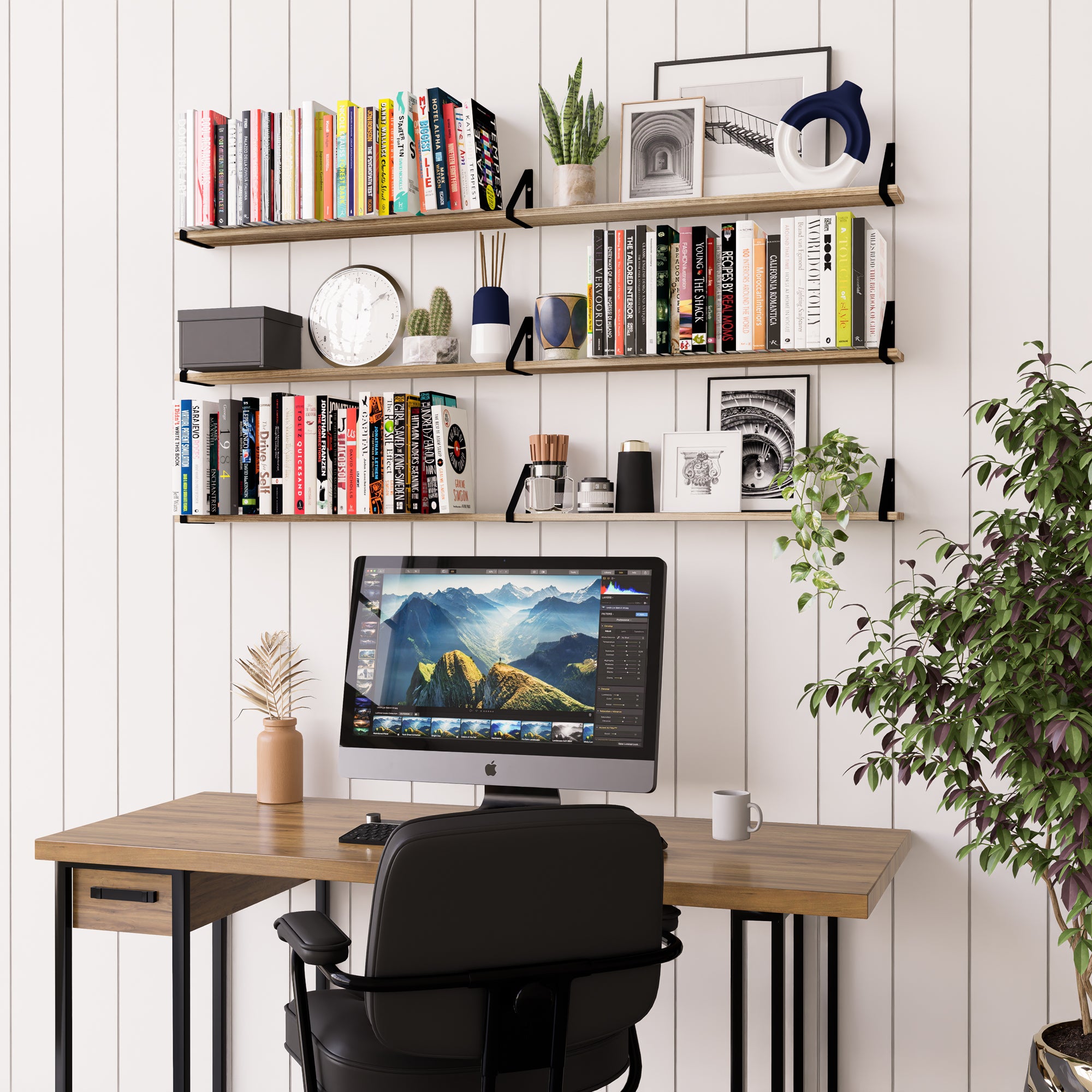 A home office space with burnt organizer shelves above a desk, neatly displaying books, plant decor, and personal items.