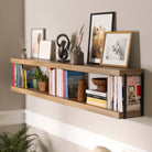 Hanging shelf for living room with books and decor supported by black rectangular heavy duty shelf brackets in a living room.