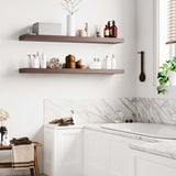 Wall shelves in a bathroom setting hold essential toiletries and decorations, adding functional storage and style above a white cabinet.