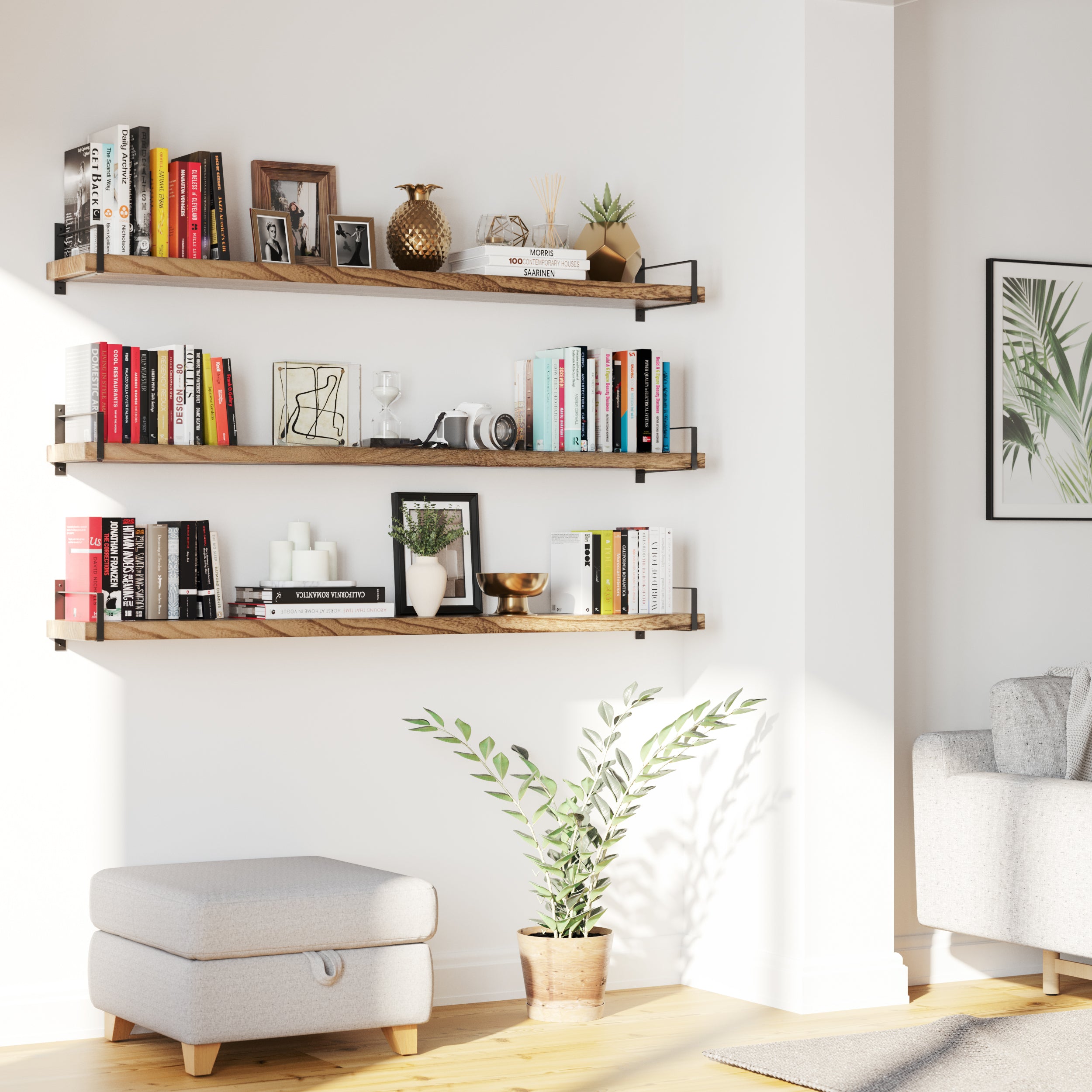 hree floating wood shelves for living room line a bright corner wall, showcasing books, framed photos, plants, and decorative items. The layout offers vertical storage with a clean, warm aesthetic perfect for cozy modern homes.