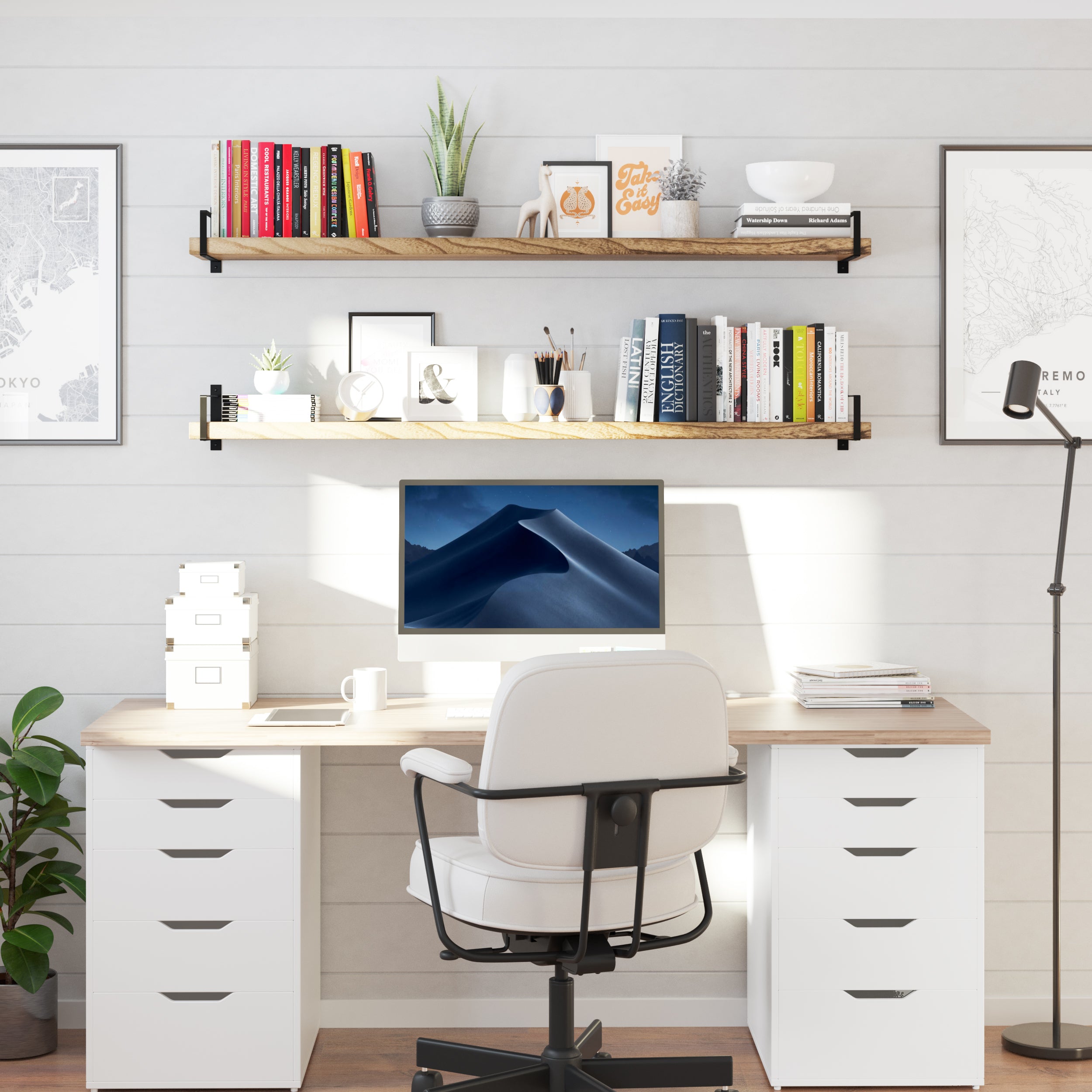 Two 60" long office shelves float above a white desk setup, filled with books, décor, candles, and framed art. It creates a visually tidy, productive workspace full of personal charm and efficient vertical use.