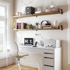 Sleek and practical, two long office shelves enhance this bright home office setup. With books, plants, and storage boxes, they offer ample space-saving storage with rustic flair.
