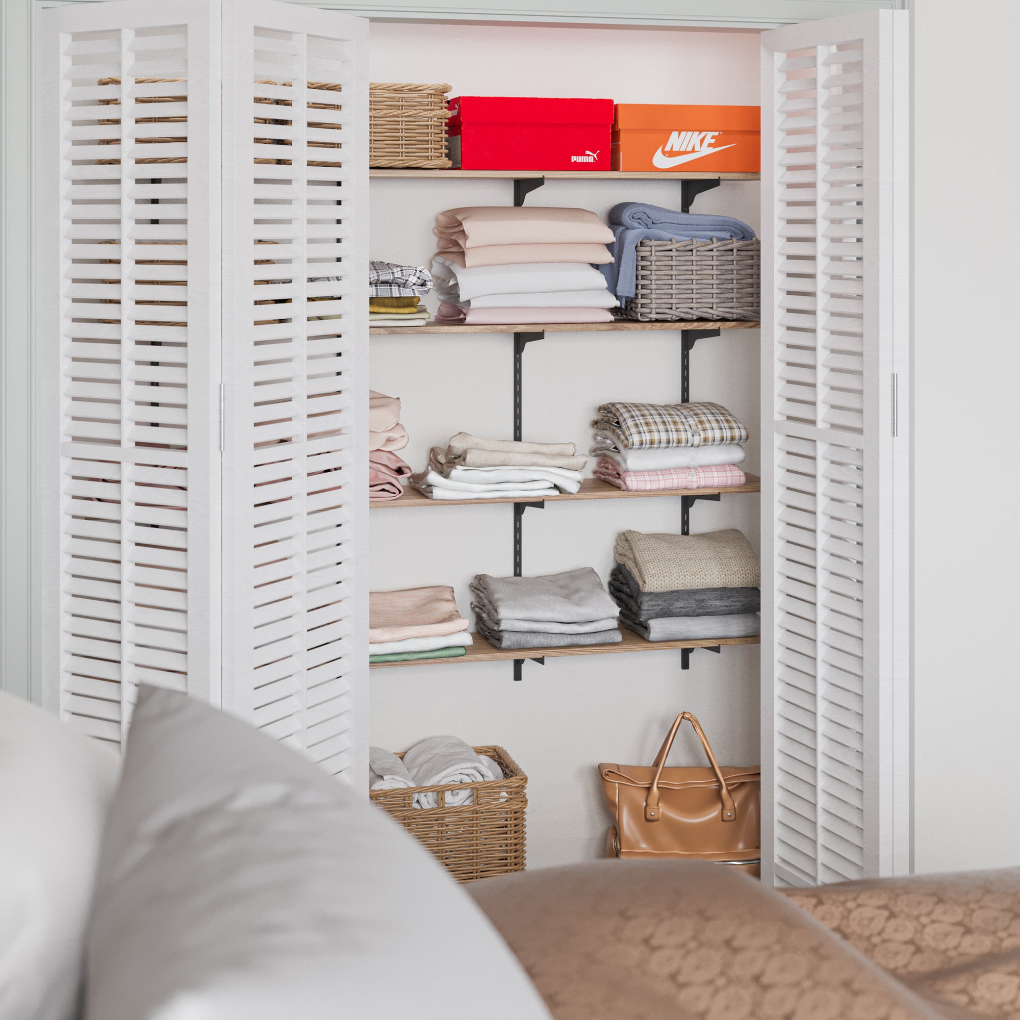 An open closet organized with bedroom shelf full of neatly folded clothes, boxes, and storage baskets, providing a practical and efficient use of space.