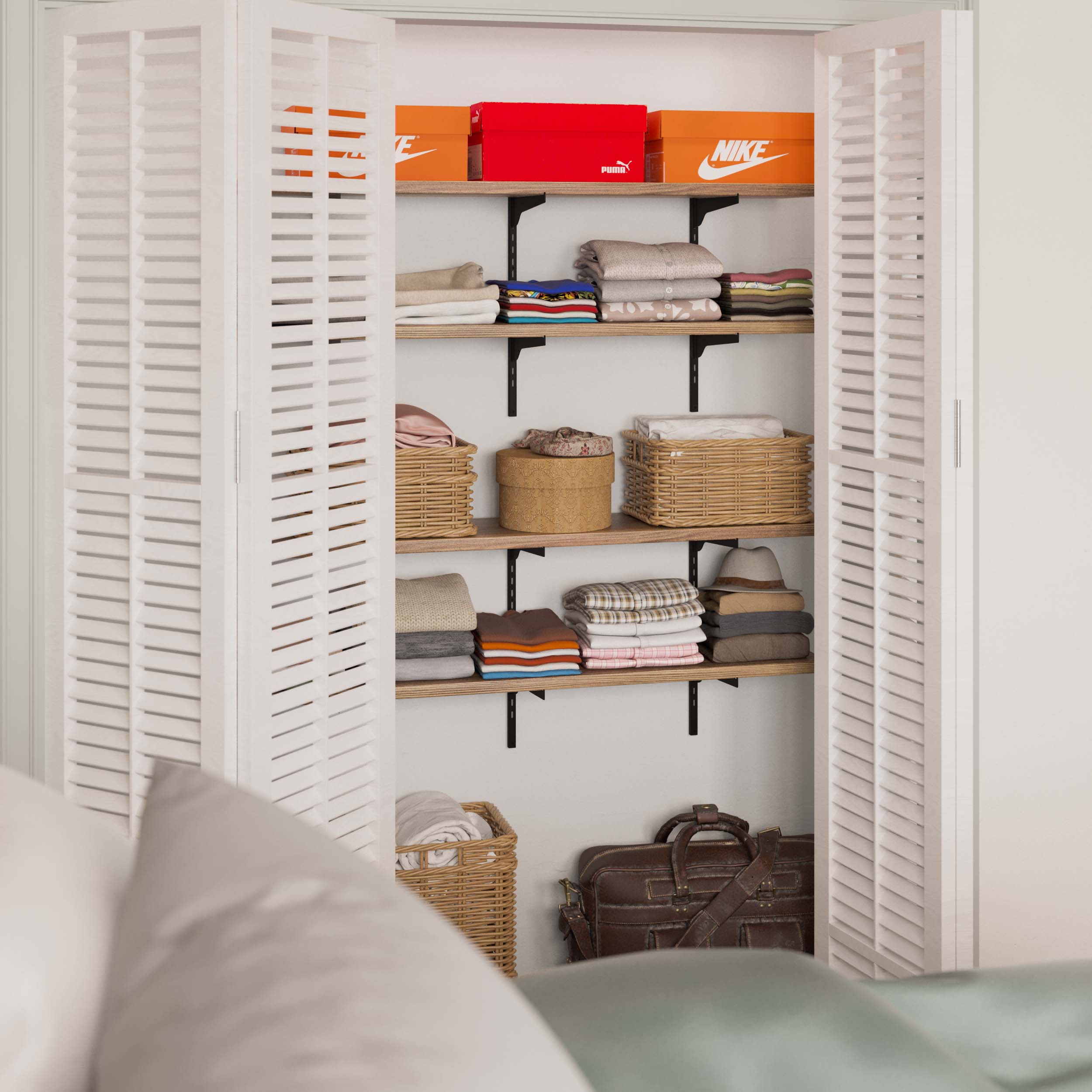 Open closet with organizer shelves organized with clothes, boxes, and baskets, offering a neat storage space.