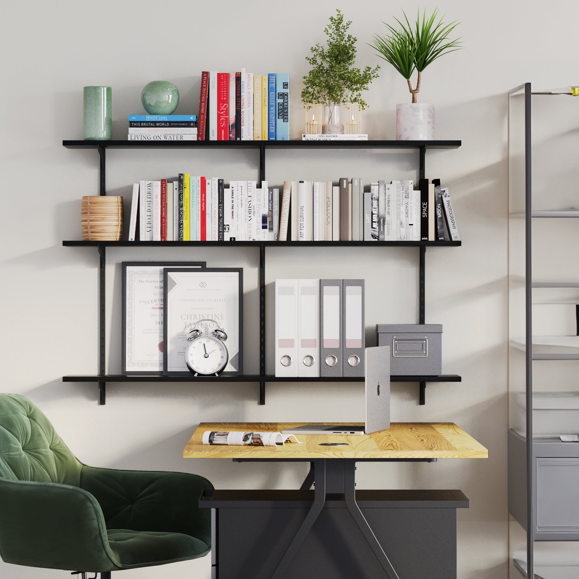 An organized home office setup with 3 tier wall shelf holding books, plants, and stylish desk accessories.