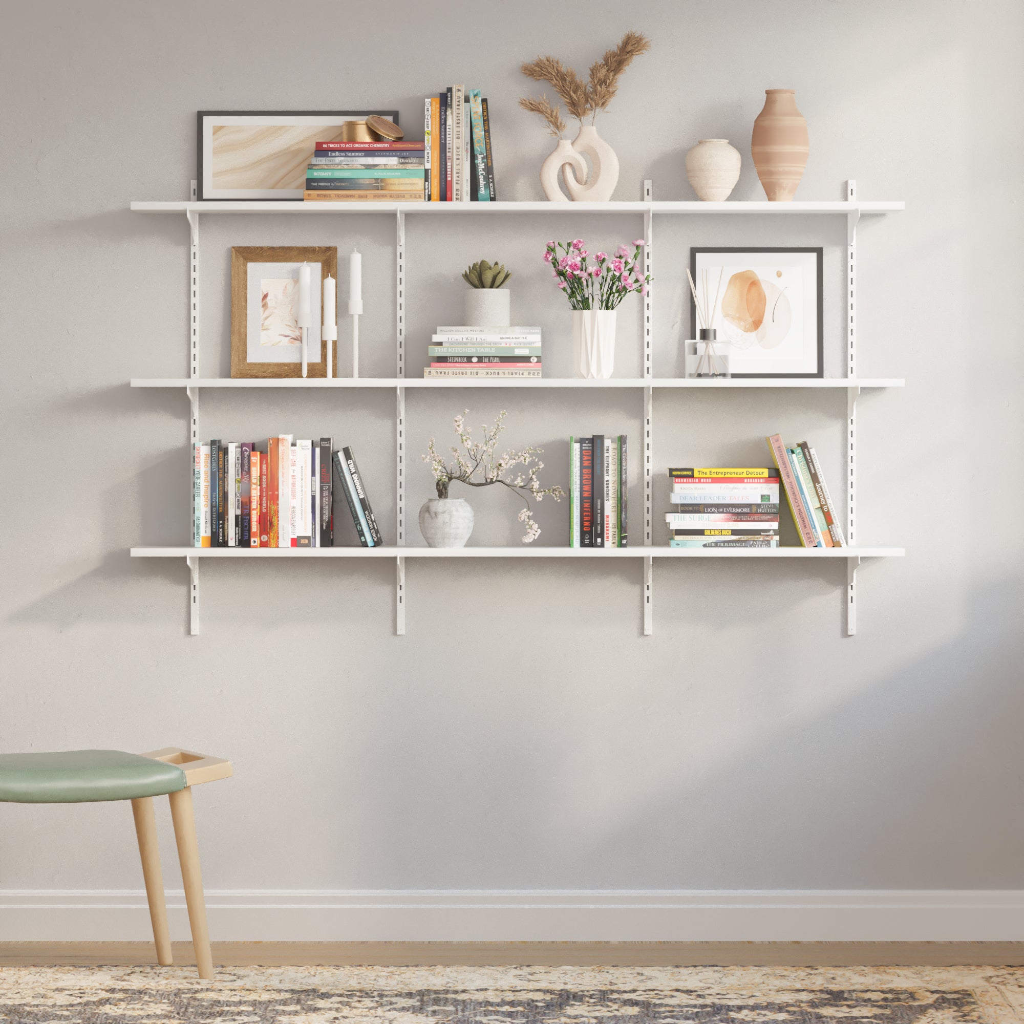 A decorative configuration of the 3 tier white shelving system with art, books, and vases on a neutral-toned wall, ideal for showcasing versatility in aesthetic arrangement.