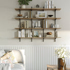 A 4-tier 60 inch long wooden storage shelf is used for soft-toned books, candles, vases, and framed art, blending into a cozy, neutral-toned living room setup.