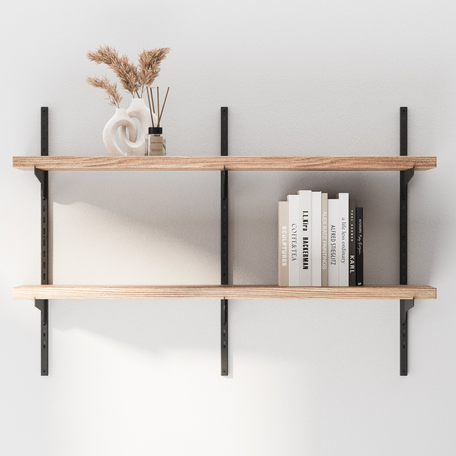 Wooden adjustable shelves with books and decorative items against a white wall