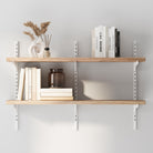 2 tier decorative shelves with books and decorative items against a light gray wall