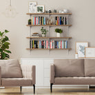 Living room with beige sofa, wooden adjustable shelves, books, and plants.