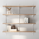 Storage shelves for living room decor with books and decor items against a light gray wall