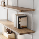 Living room shelves with books and decorative items against a white wall