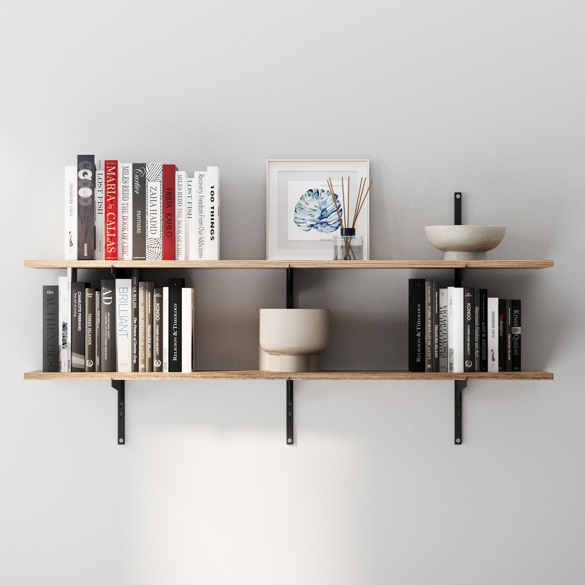 Wooden farmhouse shelves with black adjustable bracket holding books and decorative items against a gray wall