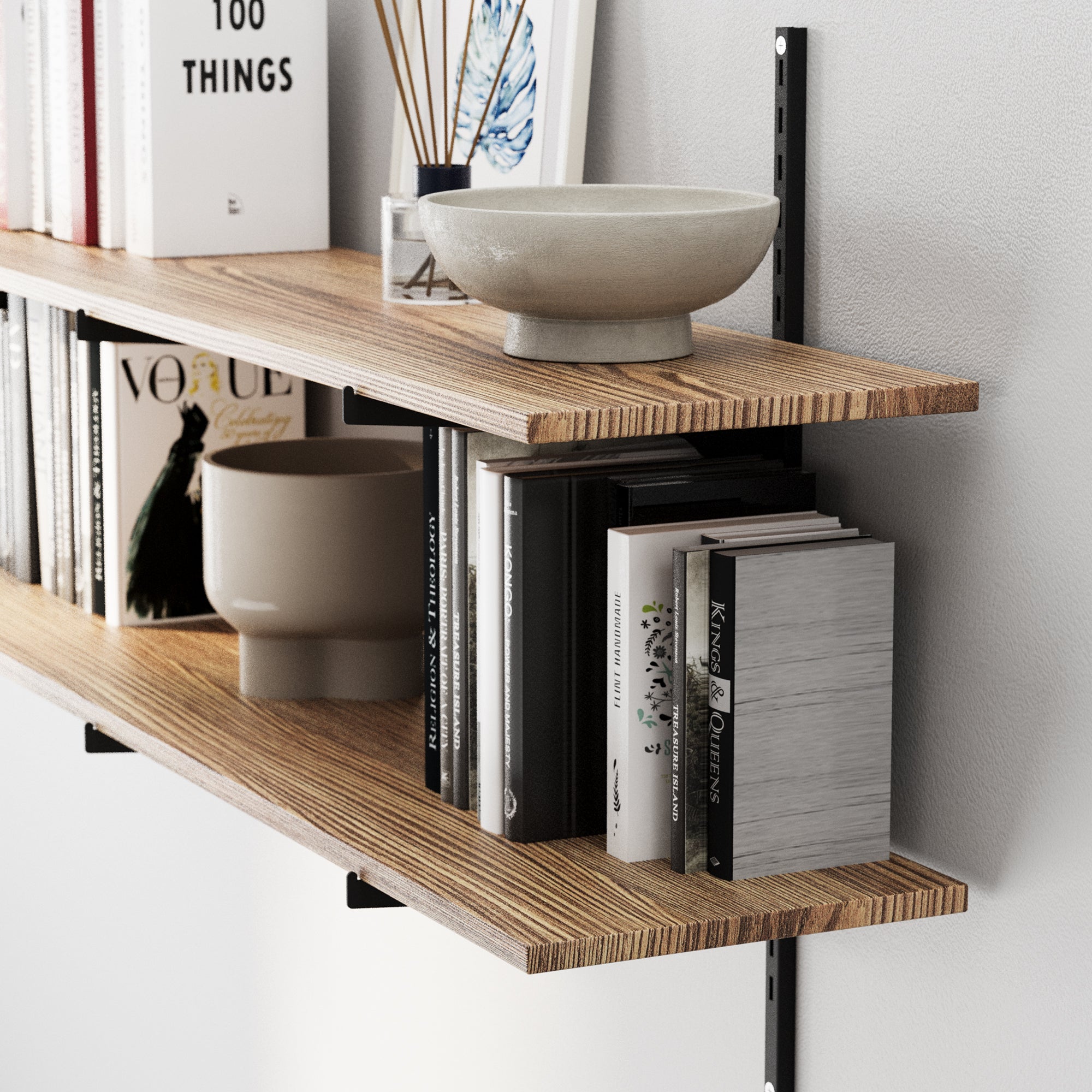 48" long floating book shelf with books and decorative bowls against a white wall