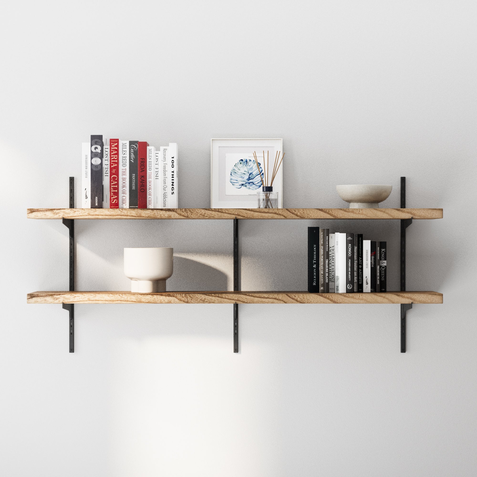 2 tier wooden adjustable shelves with books and decor items against a white wall