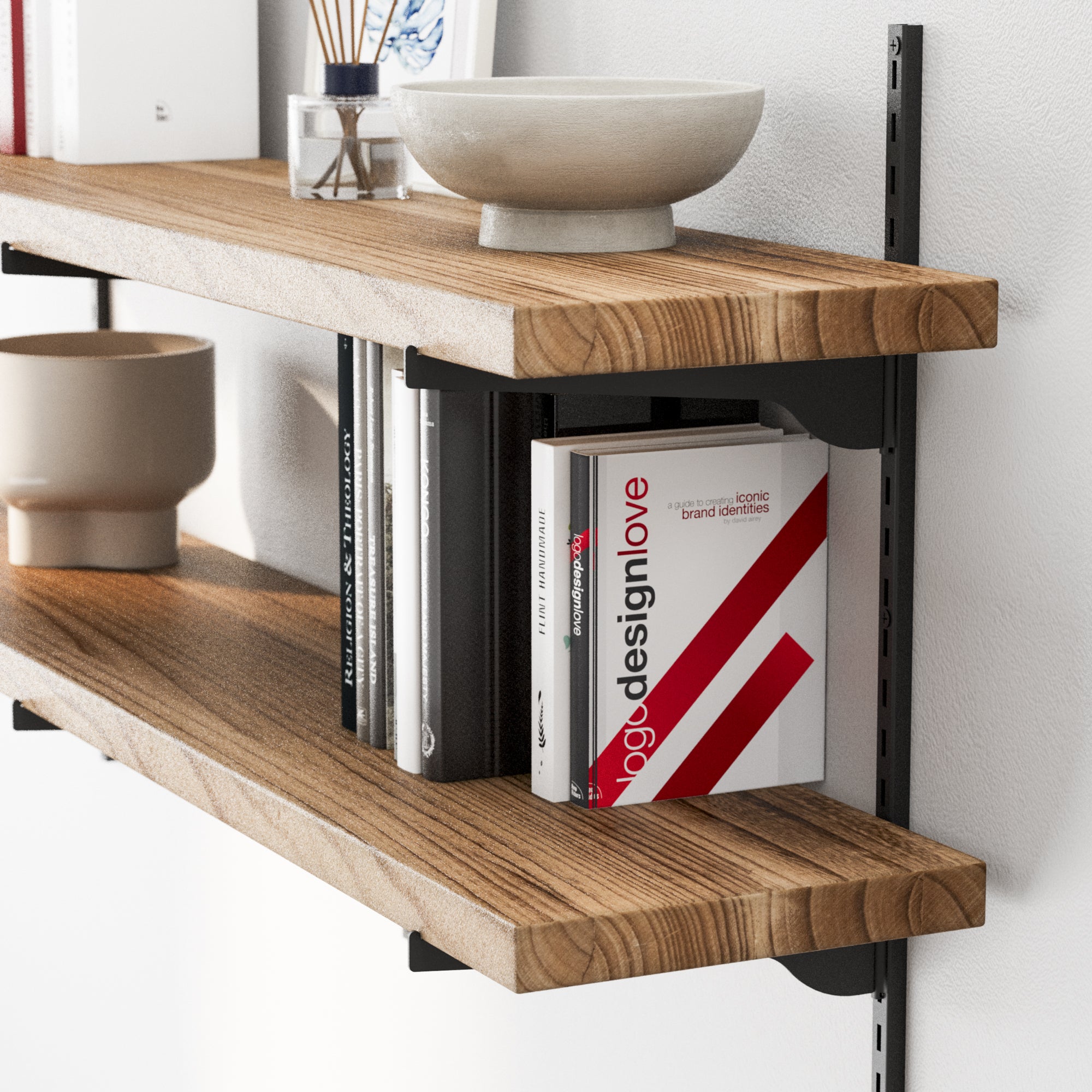 Floating wall shelf 2 tier with books and decorative items against a white wall