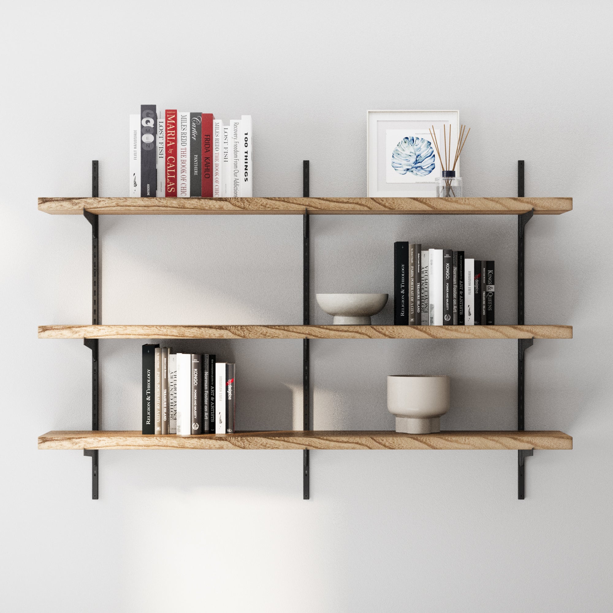 3 tier wall mounted farmhouse shelf with books and decor items against a white wall