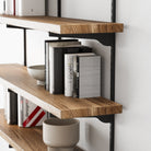 Wall bookshelf with books and decorative items against a white wall