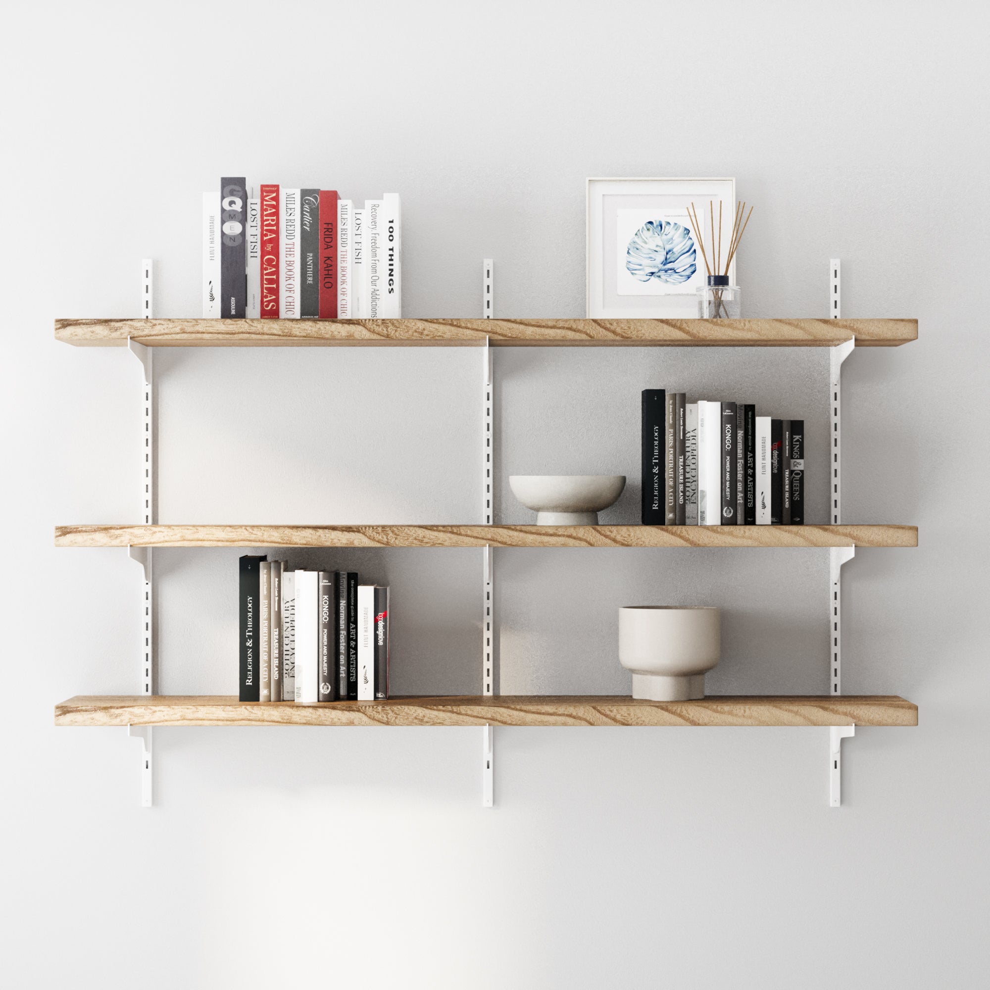 3 tier decorative shelves with white adjustable brackets with books and decor items against a white wall