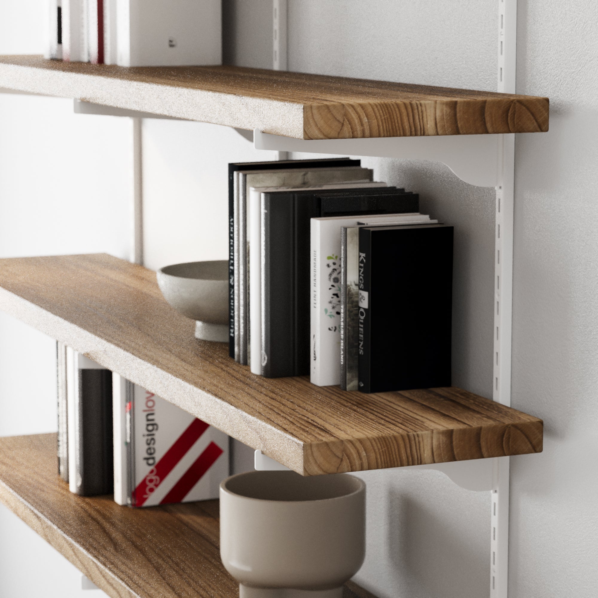 Wooden office shelves with books and decorative items against a white wall