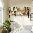 Wall-mounted shelves with books and decor in a room with a window and plant.