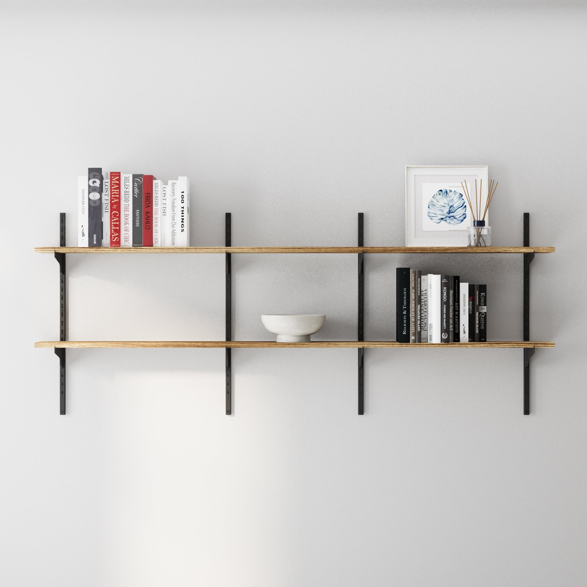 2 tier 60 inch long wooden shelves with books and decor on a plain wall
