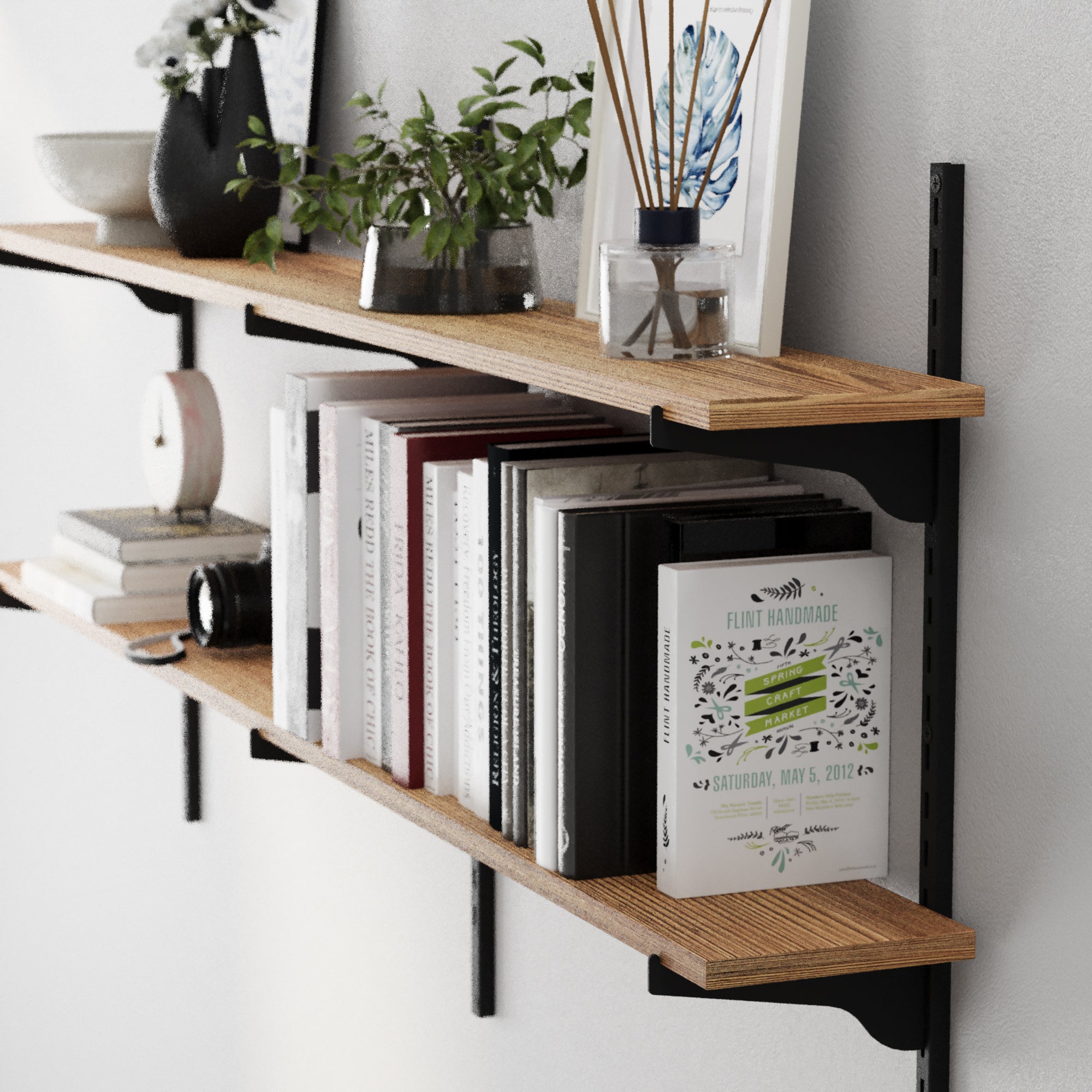 Wooden boho shelves with books and decorative items against a white wall