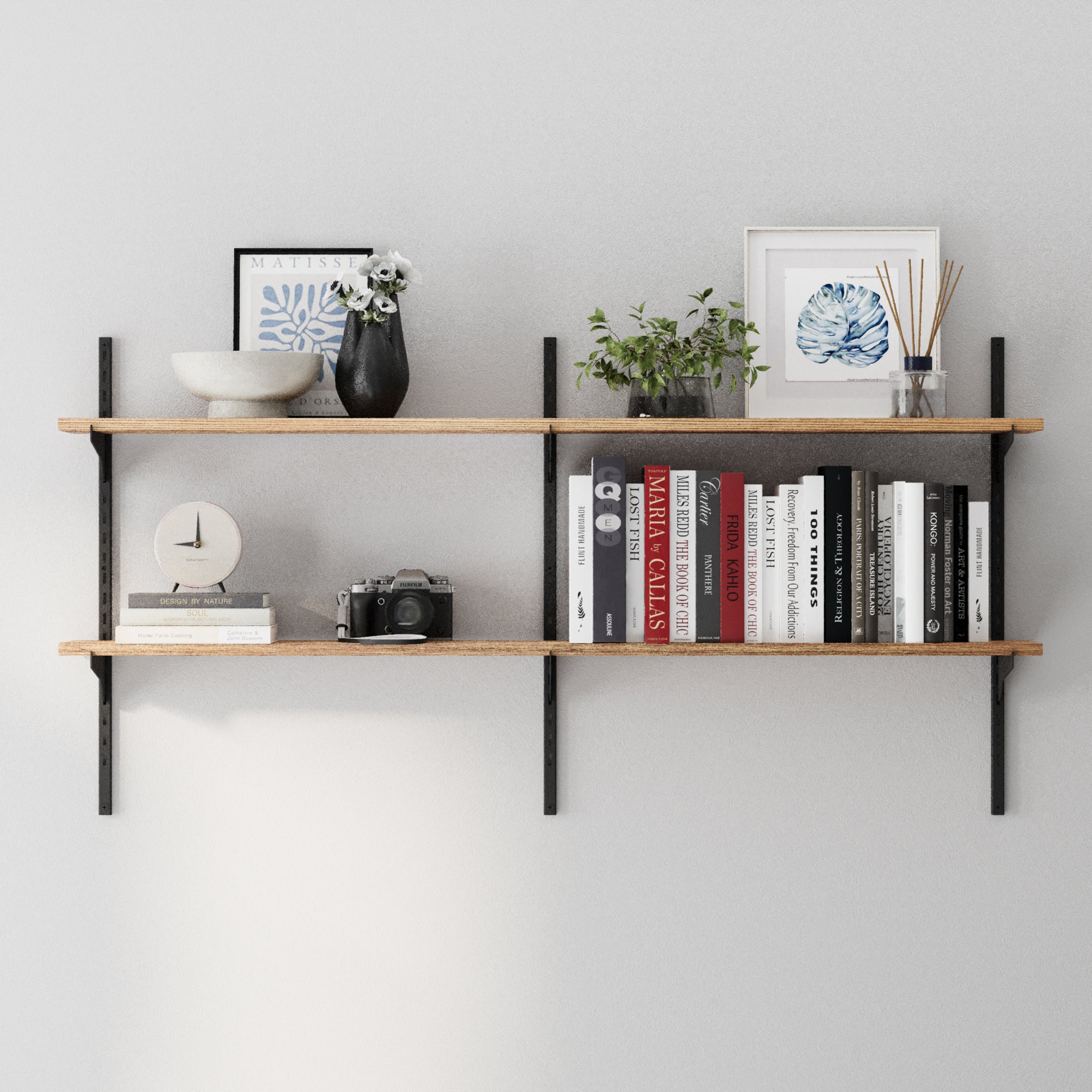 A floating bookshelf unit in a rich burnt finish with books, decorative items, and plants against a gray wall