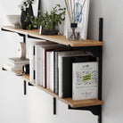 Wooden shelf with books and decorative items against a white wall
