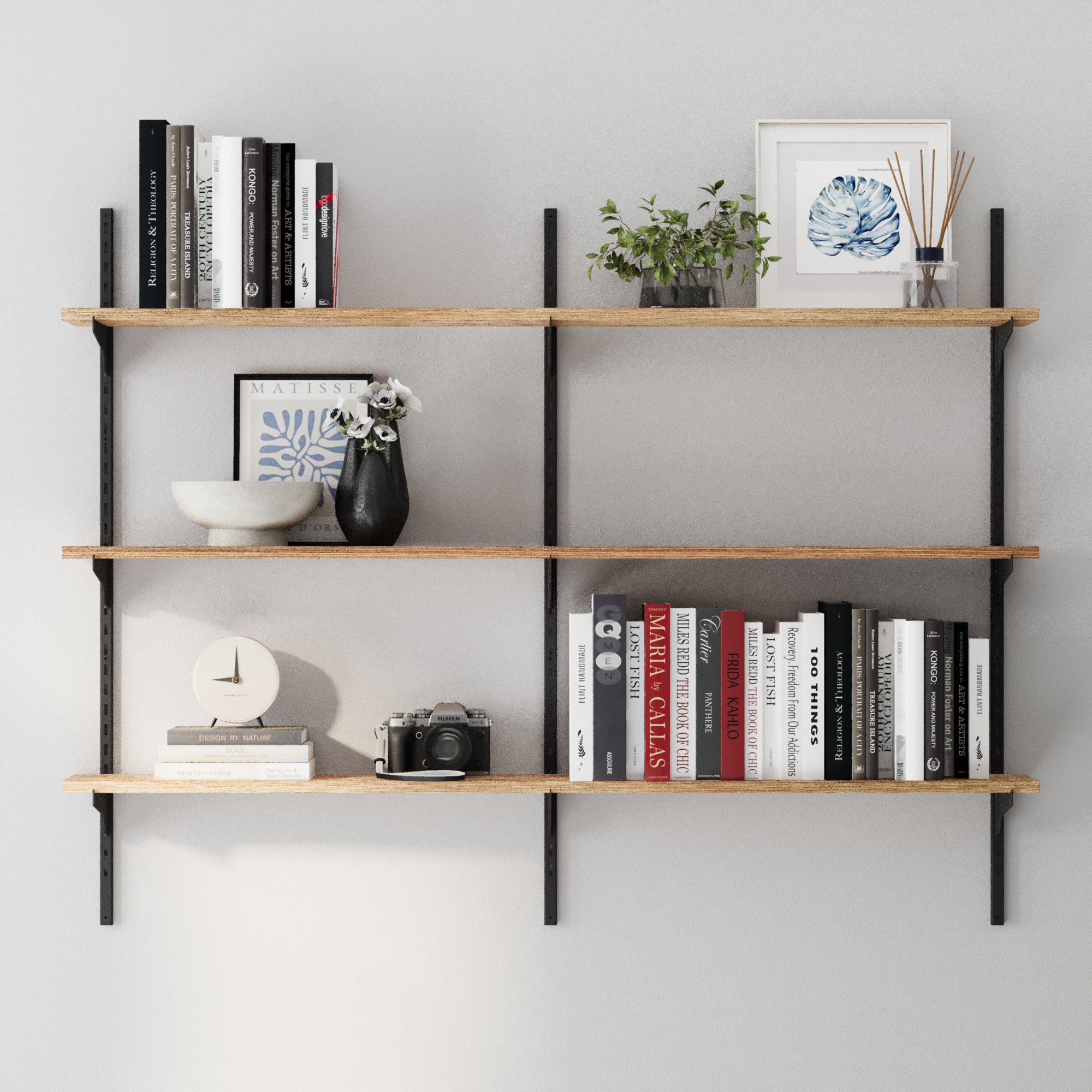 3 tier wooden shelves with books, plants, and decor against a gray wall