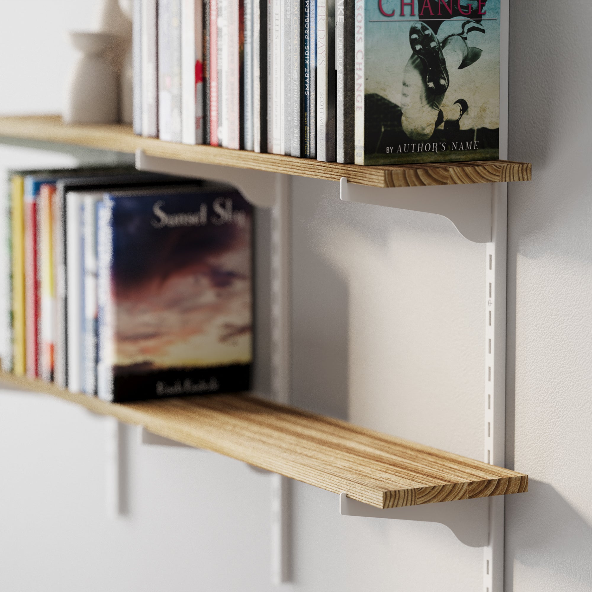 Multi tier decorative shelves with books on a white wall
