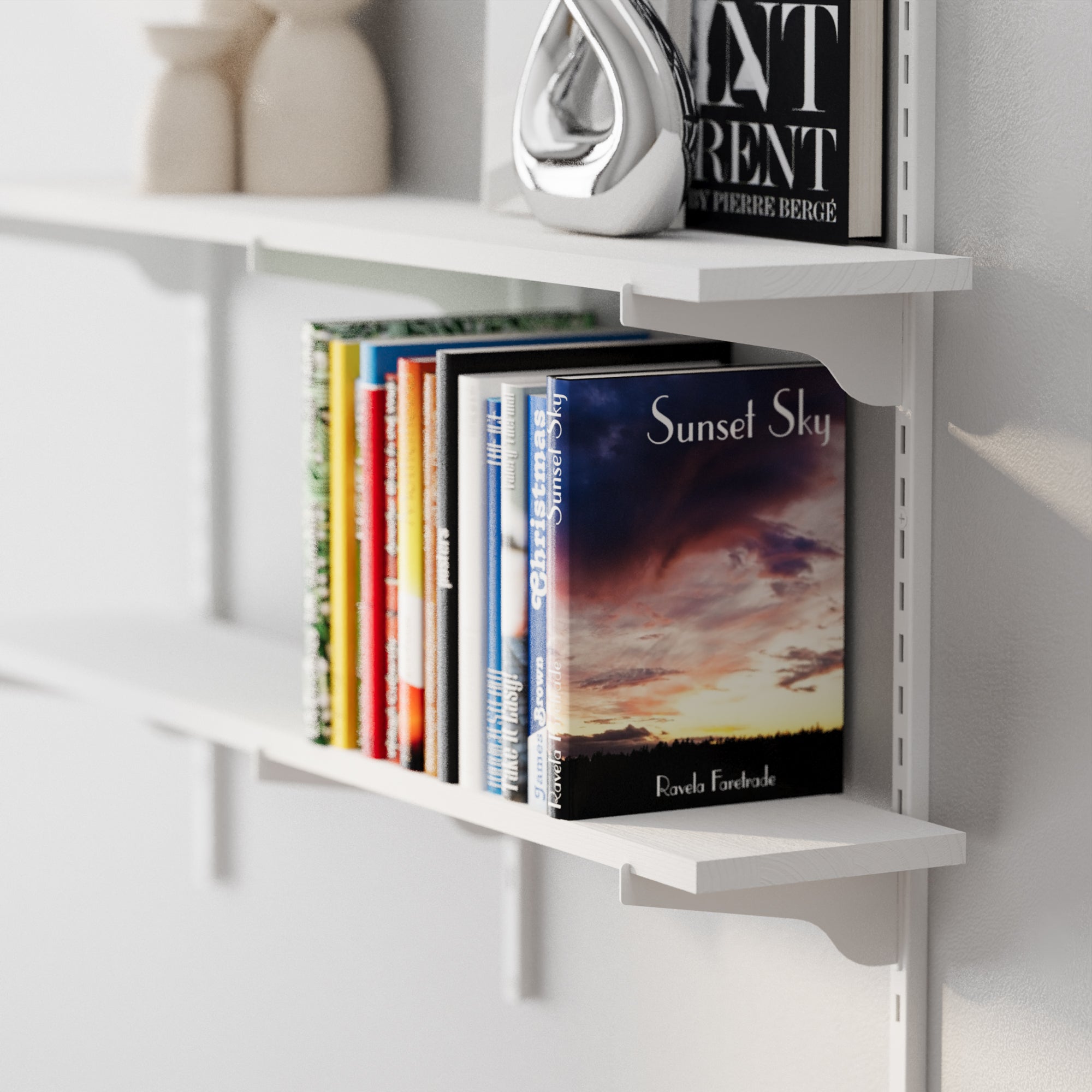 White shelf with books and decorative items against a light gray wall