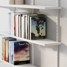 White bookshelf with books on a white background