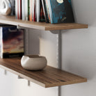 Hanging shelving unit with a small bowl on a white wall